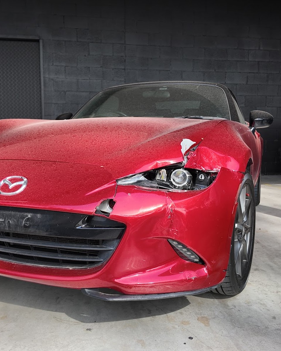 Damaged Mazda at Diverse Autobody before collision repair