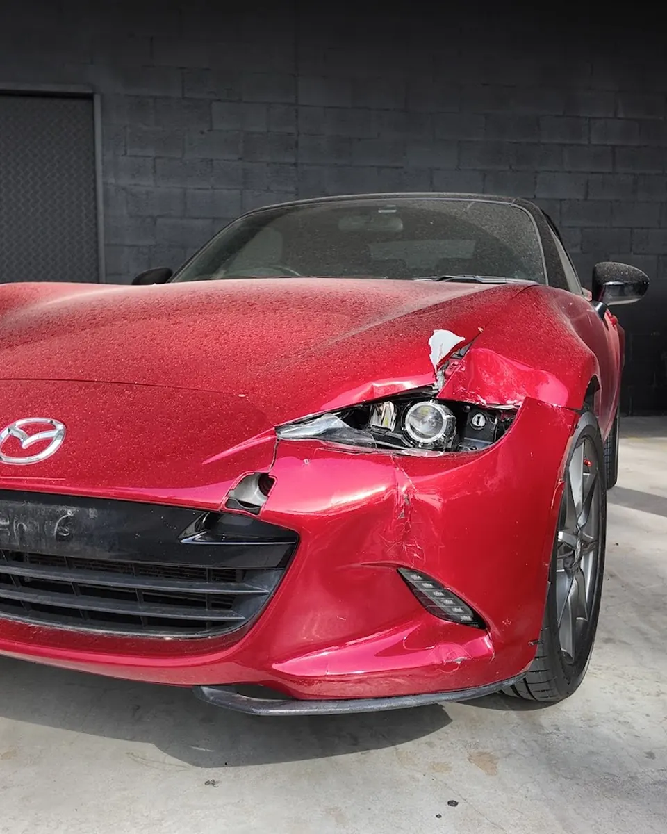 Damaged Mazda at Diverse Autobody before collision repair