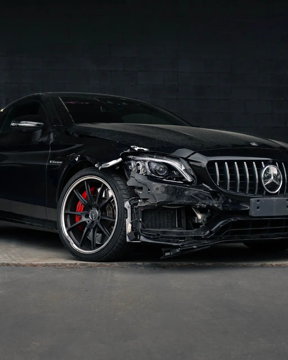 Damaged Mercedes at Diverse Autobody before collision repair